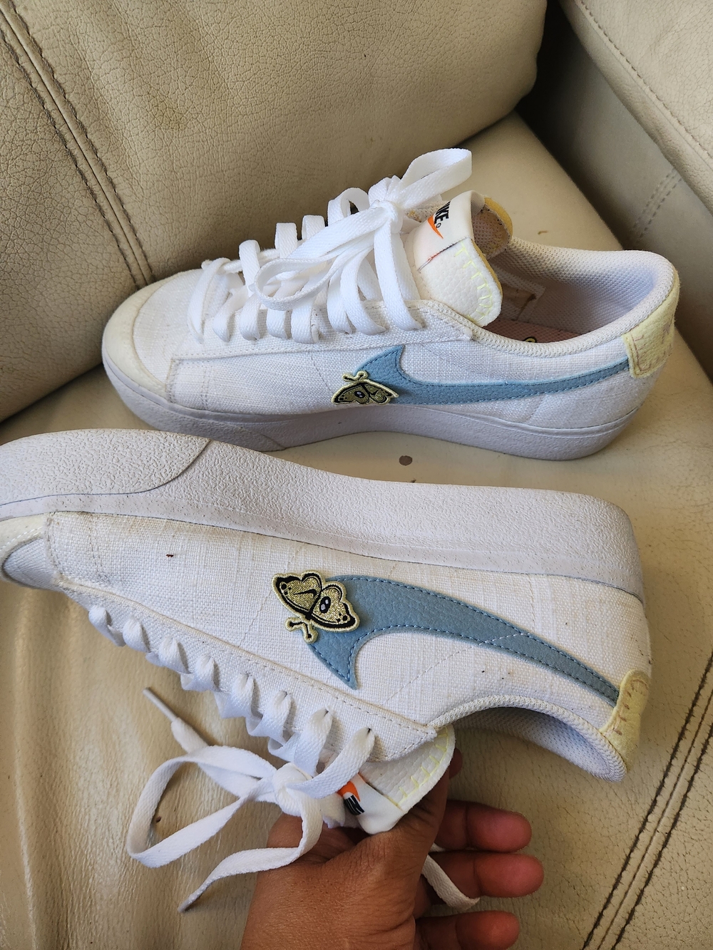 Nike White Low-Top Sneakers with Light Blue Swoosh and Bee Patch